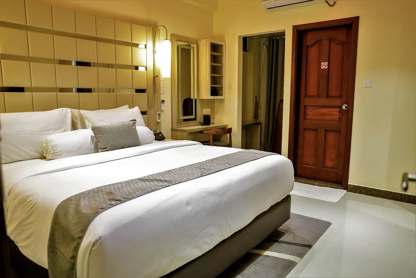 Inviting hotel bedroom with a comfortable bed, modern decor, and a no-smoking policy.